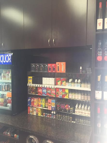Interior of Old Town Wine & Spirits: shelving, cooler, and wine wall